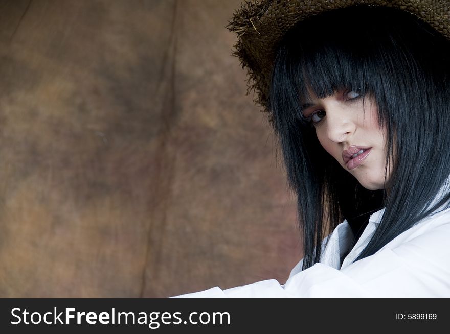 Image, in landscape orientation, of a young woman with black hair wearing a straw hat. Image, in landscape orientation, of a young woman with black hair wearing a straw hat.
