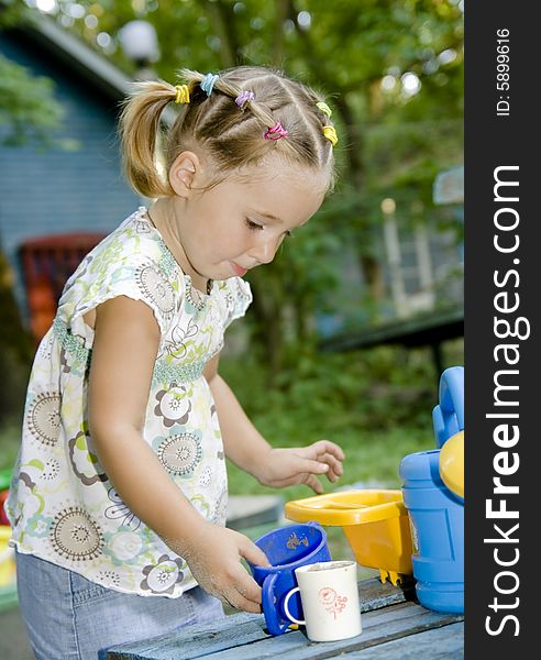 Little girl playing alone outdoor