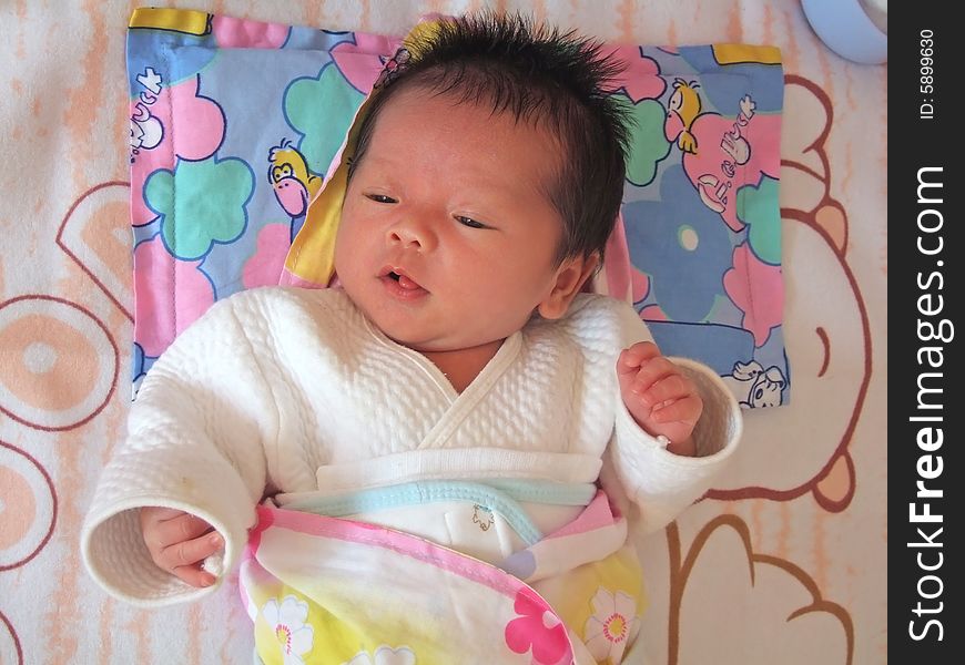 Lovely baby on a bed