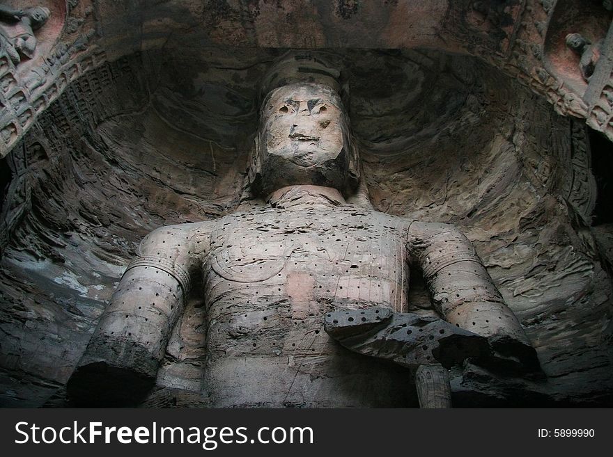 Stone carving in Yungang Grottoes, Datong, Shanxi province of China.

CAVE 17(A.D.460-465)
A crossed-legged Maitreya, 15.6 metres high, is carved on the north wall, a seated buddha on the east wall, and a standing buddha on the west wall, which are generally named The Trikala Buddhas. Stone carving in Yungang Grottoes, Datong, Shanxi province of China.

CAVE 17(A.D.460-465)
A crossed-legged Maitreya, 15.6 metres high, is carved on the north wall, a seated buddha on the east wall, and a standing buddha on the west wall, which are generally named The Trikala Buddhas.