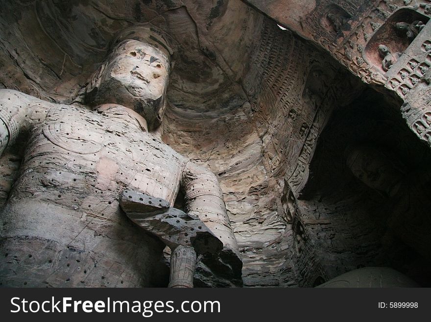 Stone carving in Yungang Grottoes, Datong, Shanxi province of China.

CAVE 17(A.D.460-465)
A crossed-legged Maitreya, 15.6 metres high, is carved on the north wall, a seated buddha on the east wall, and a standing buddha on the west wall, which are generally named The Trikala Buddhas. Stone carving in Yungang Grottoes, Datong, Shanxi province of China.

CAVE 17(A.D.460-465)
A crossed-legged Maitreya, 15.6 metres high, is carved on the north wall, a seated buddha on the east wall, and a standing buddha on the west wall, which are generally named The Trikala Buddhas.