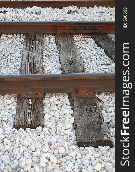 Cross-section of railroad tracks surrounded by white stones. Cross-section of railroad tracks surrounded by white stones.