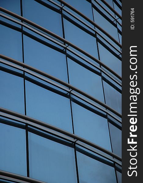 Frontal glass panels of a modern building. Frontal glass panels of a modern building.