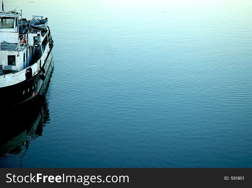 Rusty ship on the bank of Danube. Sort of a timeless bookmark, reminding us of the past decades, wealth and power. Rusty ship on the bank of Danube. Sort of a timeless bookmark, reminding us of the past decades, wealth and power.