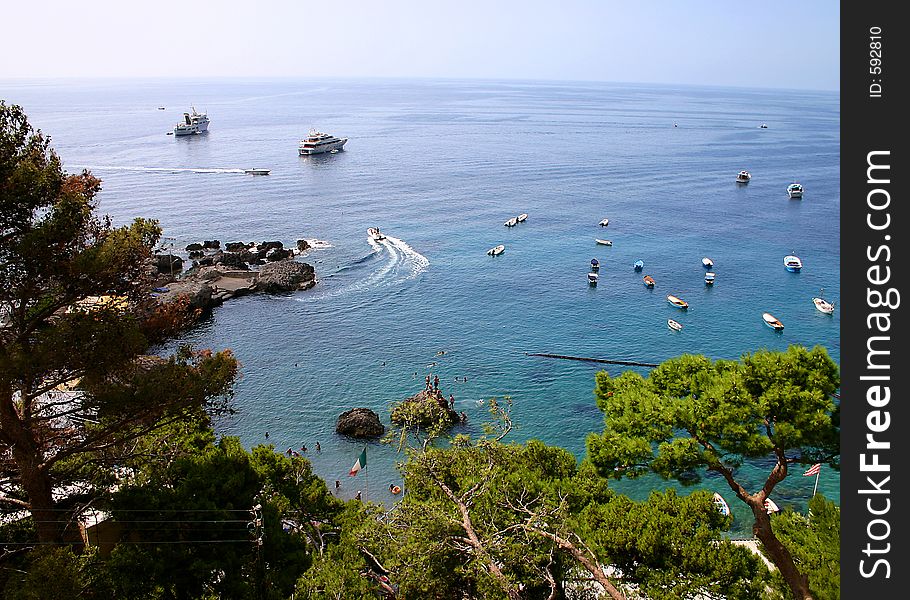 Boats of all shapes and sizes are moored in the beautiful blue-green ocean water. Boats of all shapes and sizes are moored in the beautiful blue-green ocean water.