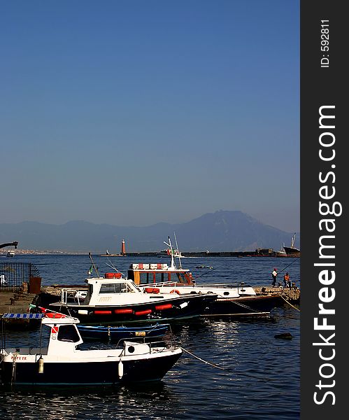 Boats docked with Mt. Vesuvius in the background. Boats docked with Mt. Vesuvius in the background.