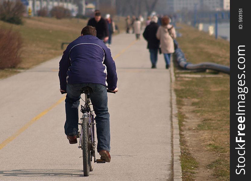 Bicyclist On Promenade