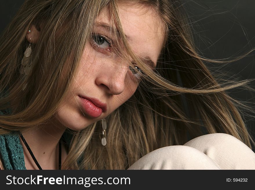 Closeup shot of a teenager with her hair blowing across her face. Closeup shot of a teenager with her hair blowing across her face