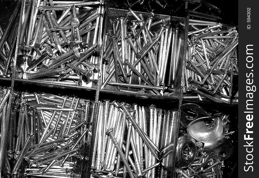 Black and white of a box of nails.