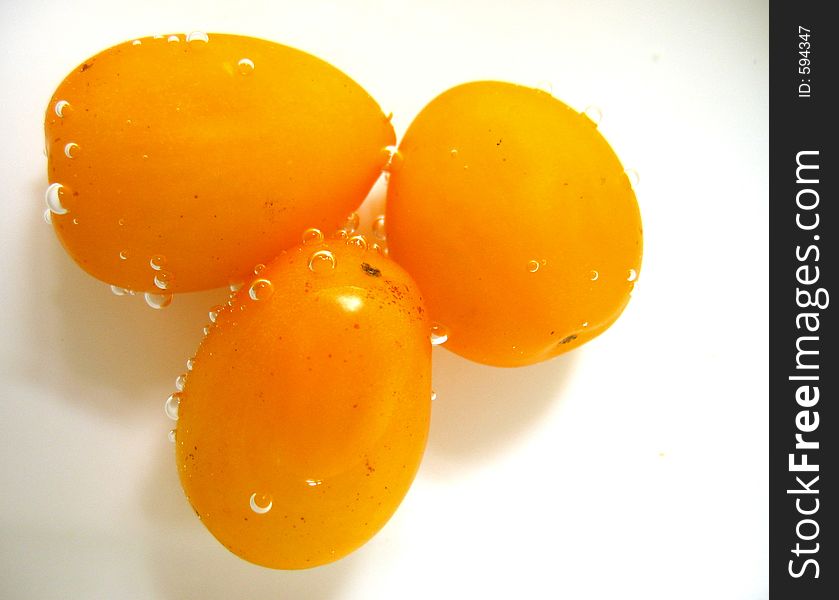 Air bubbles surrounding 3 cherry tomatoes. Air bubbles surrounding 3 cherry tomatoes