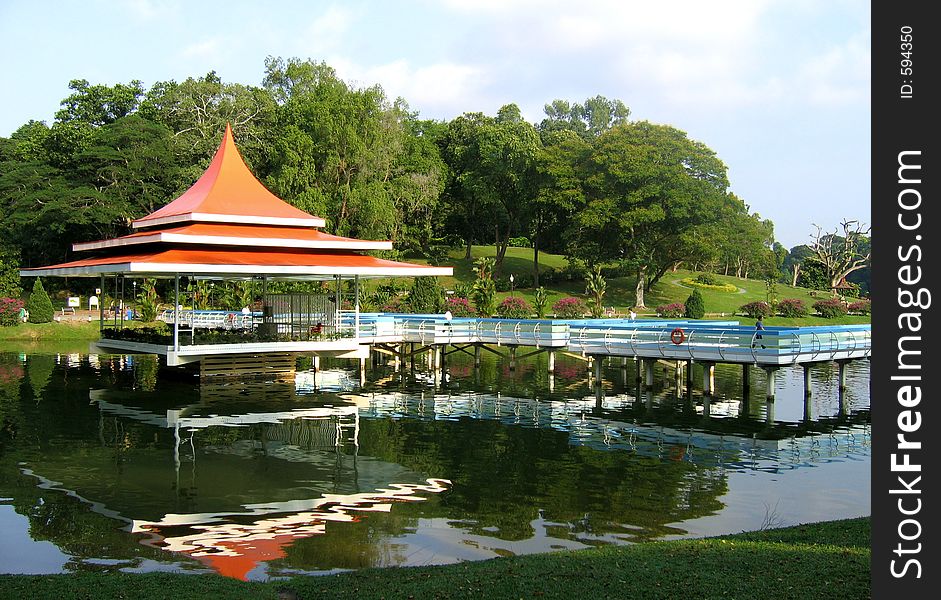 Serene and relaxing park in tropical reservoir with reflections in the water. Serene and relaxing park in tropical reservoir with reflections in the water.
