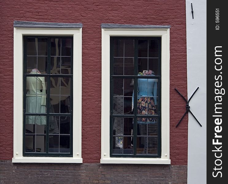 Two windows on a red wall