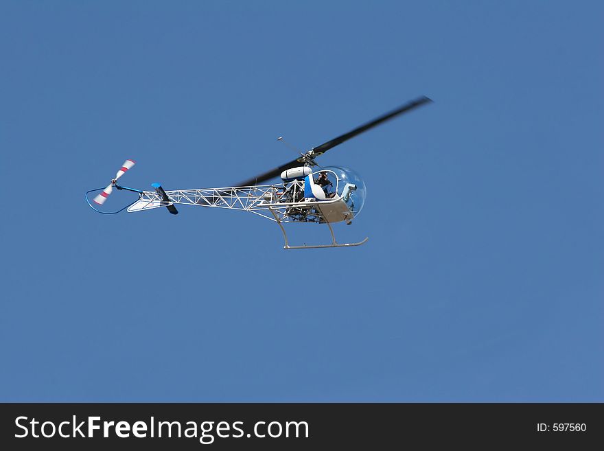 Photographer taking photos of activity on ground well flying overhead. Photographer taking photos of activity on ground well flying overhead