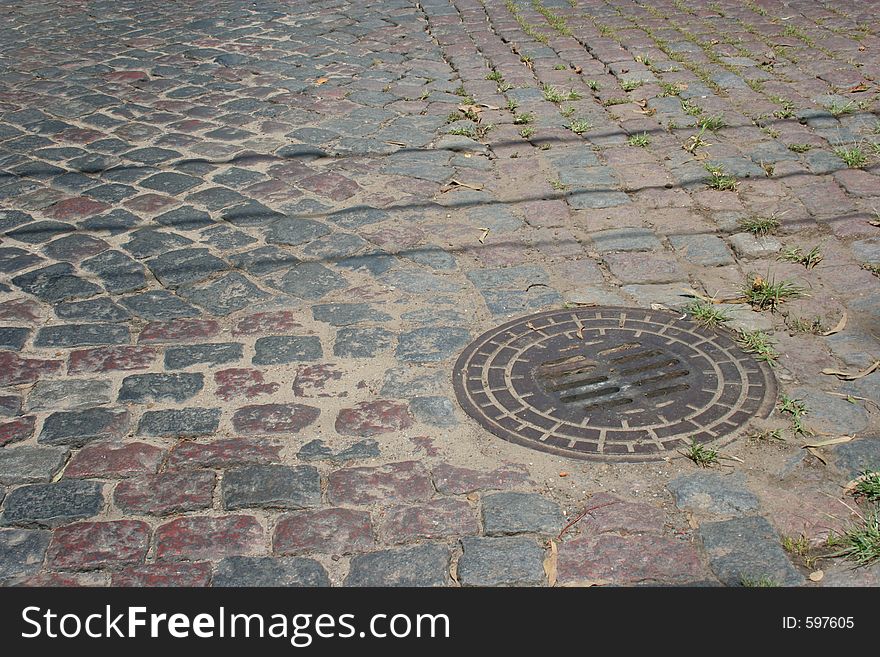 Culvert in paving stones. Urban street