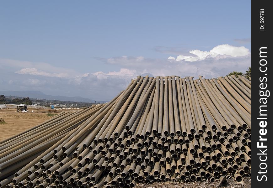 Long shot of metal irrigation pipes. Long shot of metal irrigation pipes