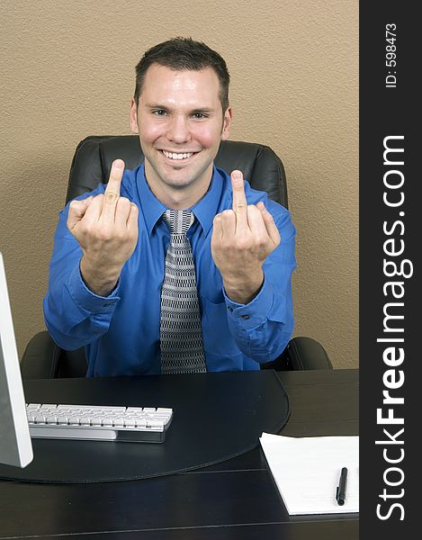 Angry employee giving the finger with both hands, carrying a fake and forced smile on his face. Angry employee giving the finger with both hands, carrying a fake and forced smile on his face