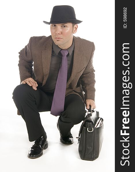 Slick businessman ready to go, grabbing his briefcase.