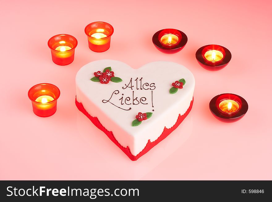 Heartshaped mothersday tart surrounded by candles. Heartshaped mothersday tart surrounded by candles