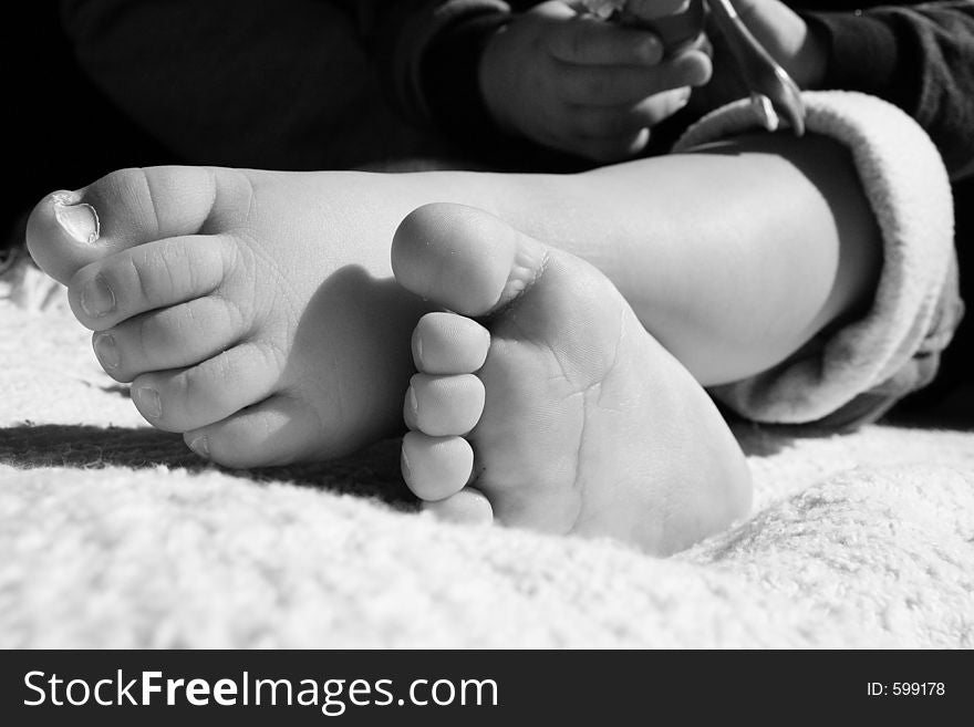 Black and white of toddlers feet crossed. Black and white of toddlers feet crossed