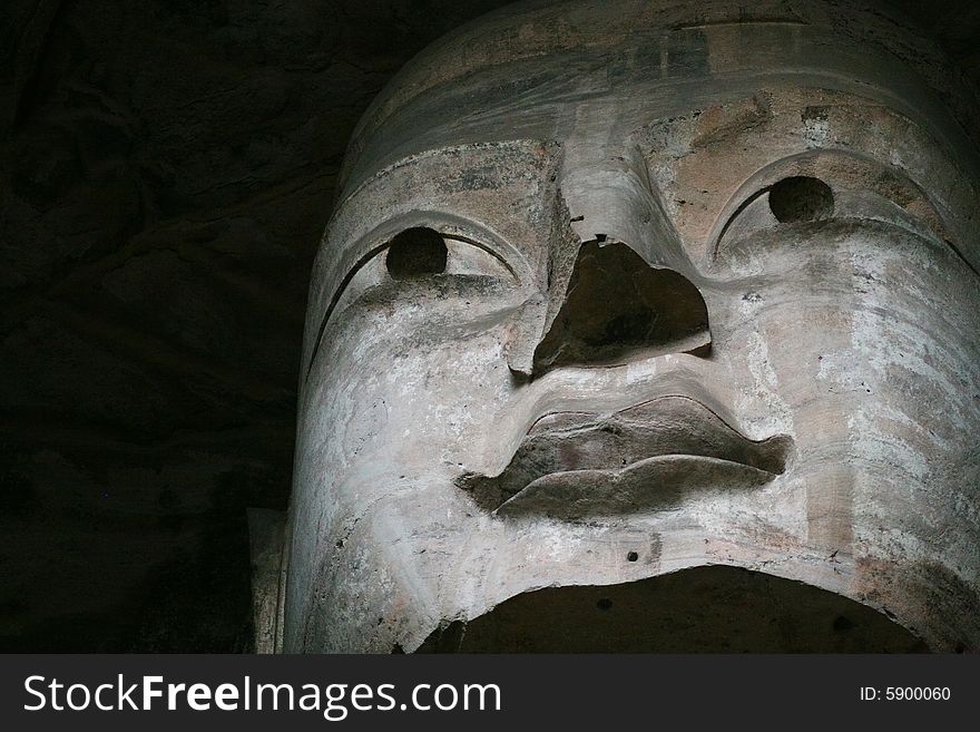 Stone carving in Yungang Grottoes, Datong, Shanxi province of China. CAVE 19(A.D.460-465) The main images are the Trikala buddhas. The seated Sakyamuni in the main cave is 16.8 metres high, the 2nd largest in the Yungang caves. Wearing a well-decorated kasaya. He has a squarely-round face, broad shoulders and long earlobes down to his shoulders. Stone carving in Yungang Grottoes, Datong, Shanxi province of China. CAVE 19(A.D.460-465) The main images are the Trikala buddhas. The seated Sakyamuni in the main cave is 16.8 metres high, the 2nd largest in the Yungang caves. Wearing a well-decorated kasaya. He has a squarely-round face, broad shoulders and long earlobes down to his shoulders.