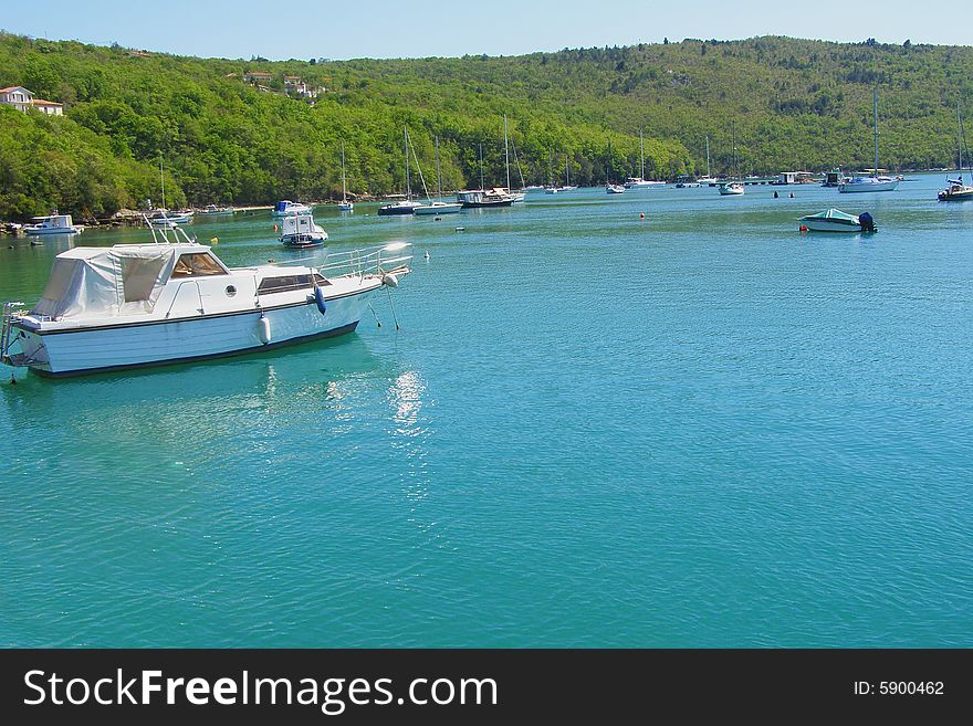 Trget and Rasa Bay (Istria - Croatia) postcard: beautiful landscape of a verdant Rasa River Bay with dock, fishing boats and yachts