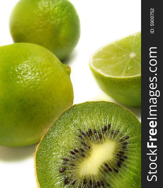 A groups of half and whole fresh kiwis and limes isolated on white background. A groups of half and whole fresh kiwis and limes isolated on white background