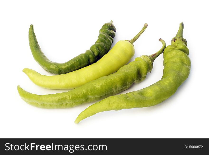 Four pods of green pepper on white background