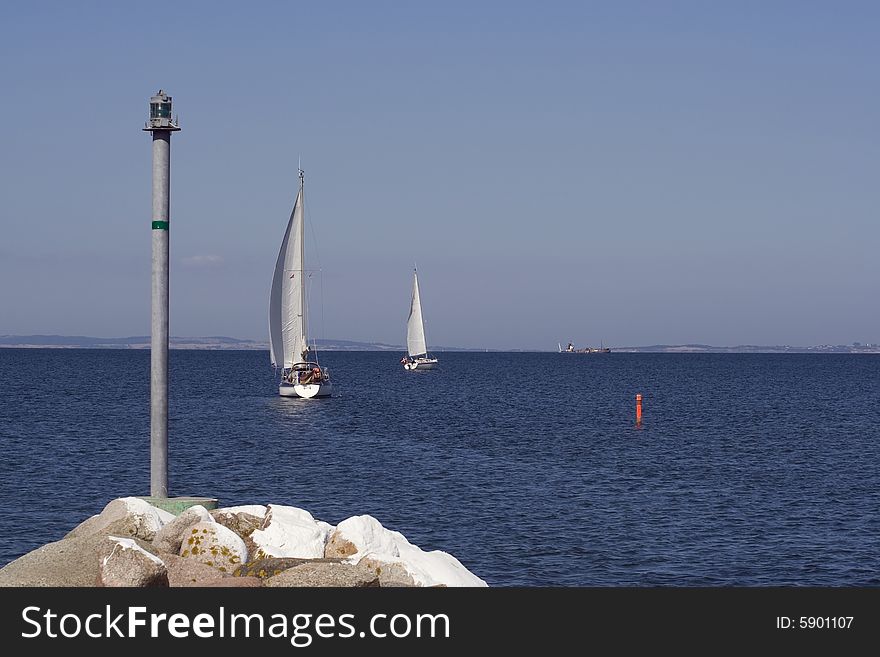 Sailing boats leaving the small harbour Norsminde, Denmark. Sailing boats leaving the small harbour Norsminde, Denmark