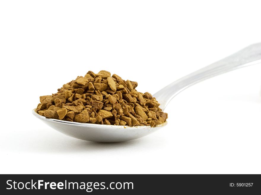 Isolated photo of a spoon felled with coffee. Isolated photo of a spoon felled with coffee