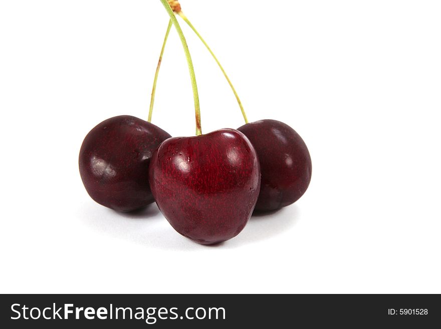 Three red cherries isolated on white background. Three red cherries isolated on white background