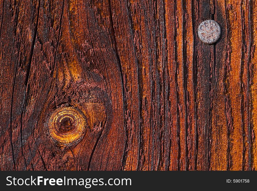 Macro of a nail and a knot in a wooden plank. Macro of a nail and a knot in a wooden plank.