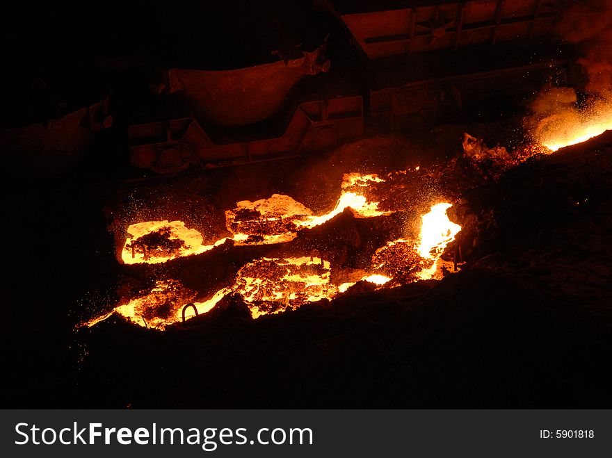 Glowing, molten hot steel. Stell casting. Glowing, molten hot steel. Stell casting.