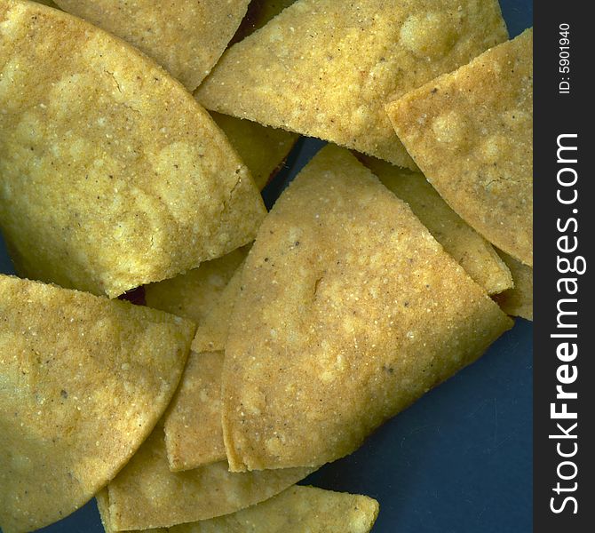 Isolated Tortilla Chips on a Navy Blue Field