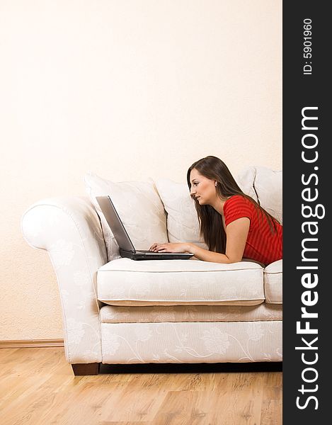 Woman With A Laptop On A Lounge