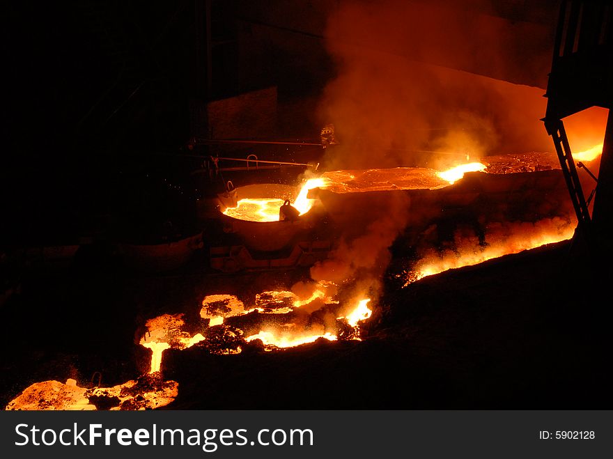 Glowing, molten hot steel. Stell casting. Glowing, molten hot steel. Stell casting.