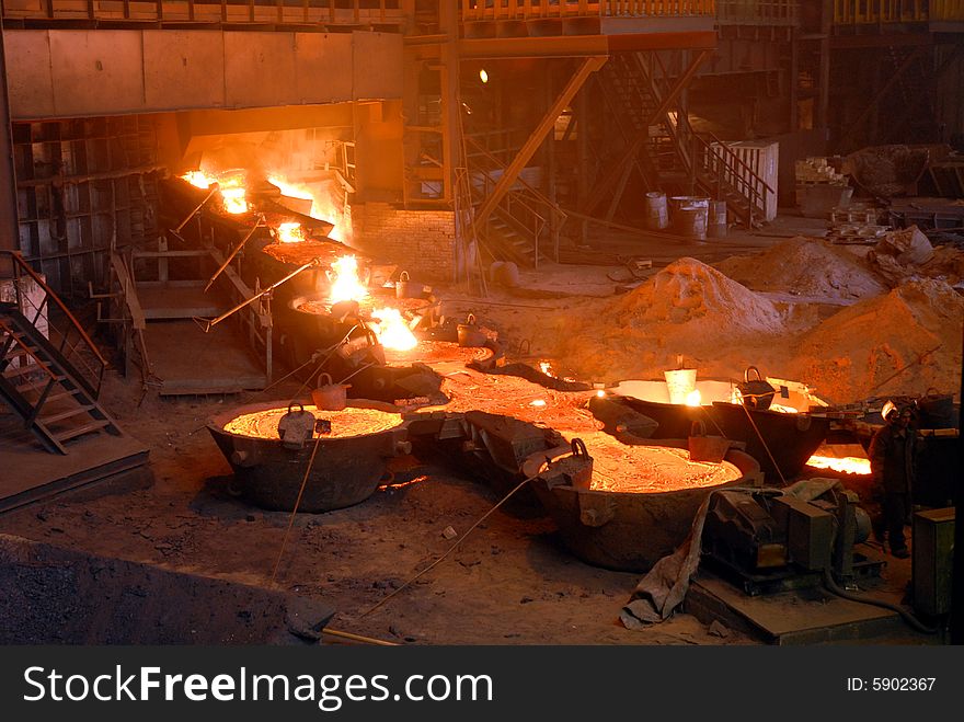 Glowing, molten hot steel. Stell casting. Glowing, molten hot steel. Stell casting.