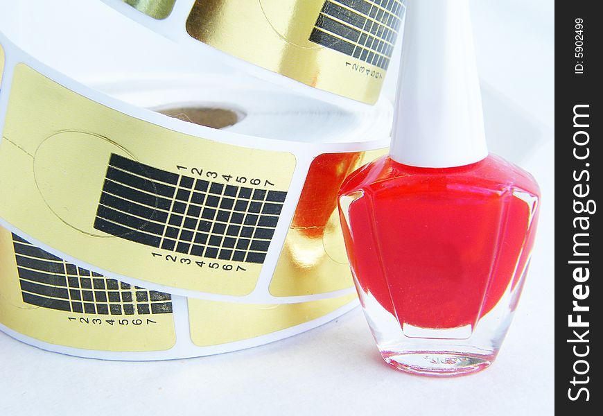 Red nail polish on a white background