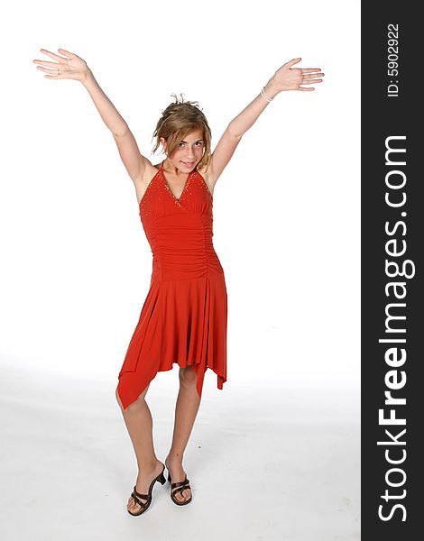 Pretty pre-teen girl in red dress with arms out. Pretty pre-teen girl in red dress with arms out