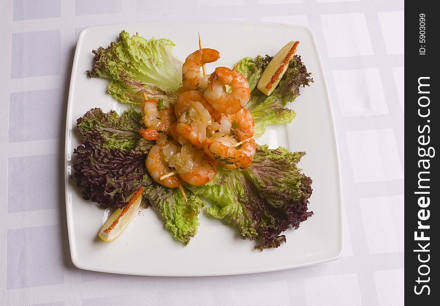 Shrimp's salad with lemon slices on white plate. Shrimp's salad with lemon slices on white plate