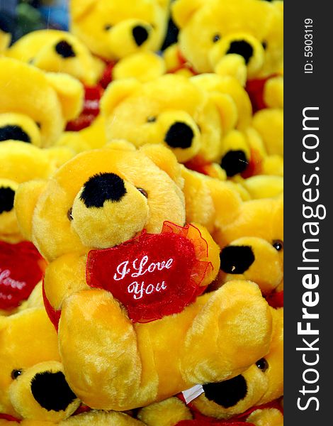 Many yellow toy bears with heart