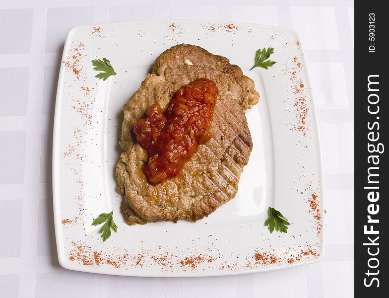 Meal cutlet with tomatoes sauce
