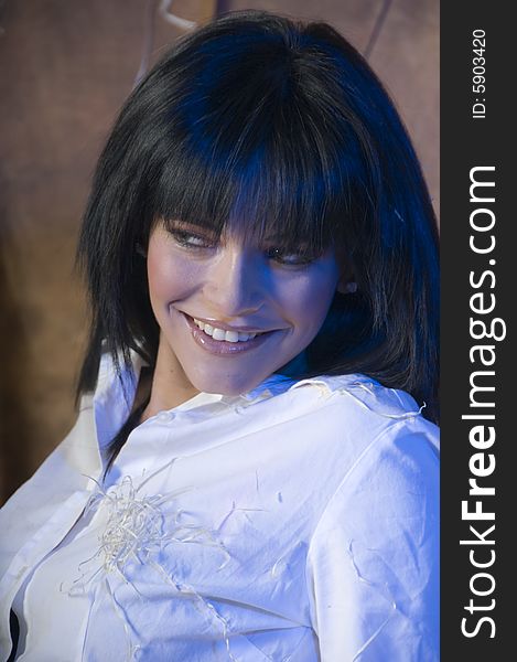 Portrait of a young lady smiling with a white shirt with bits of straw.  There is a subtle blue tinge in her hair and on her face and shirt. Portrait of a young lady smiling with a white shirt with bits of straw.  There is a subtle blue tinge in her hair and on her face and shirt.