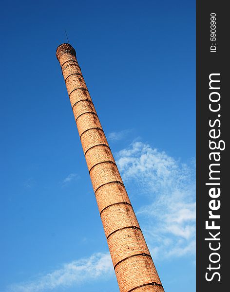 Tall brick tower towards the blue sky