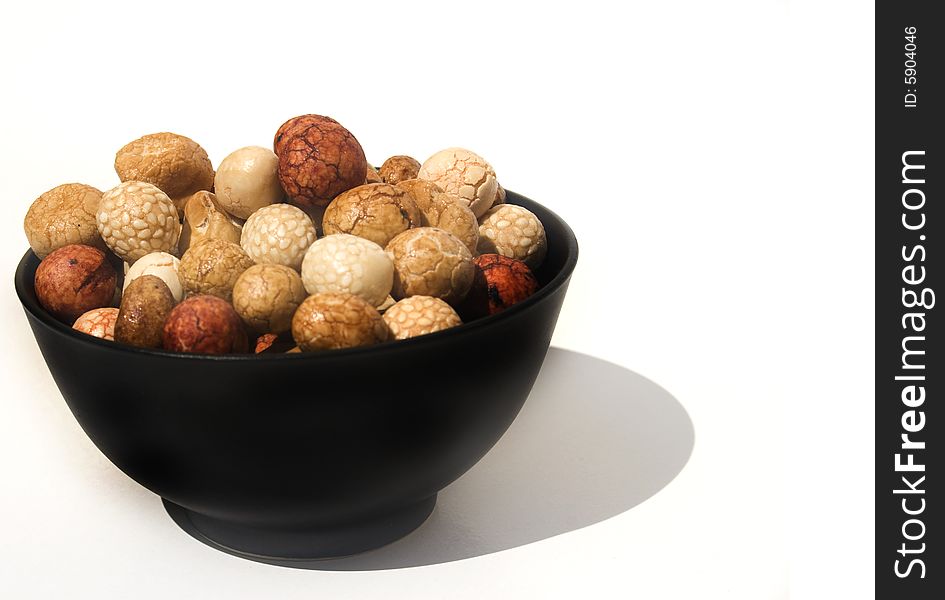 Bowl of Asian rice and sesame crackers against white background. Bowl of Asian rice and sesame crackers against white background