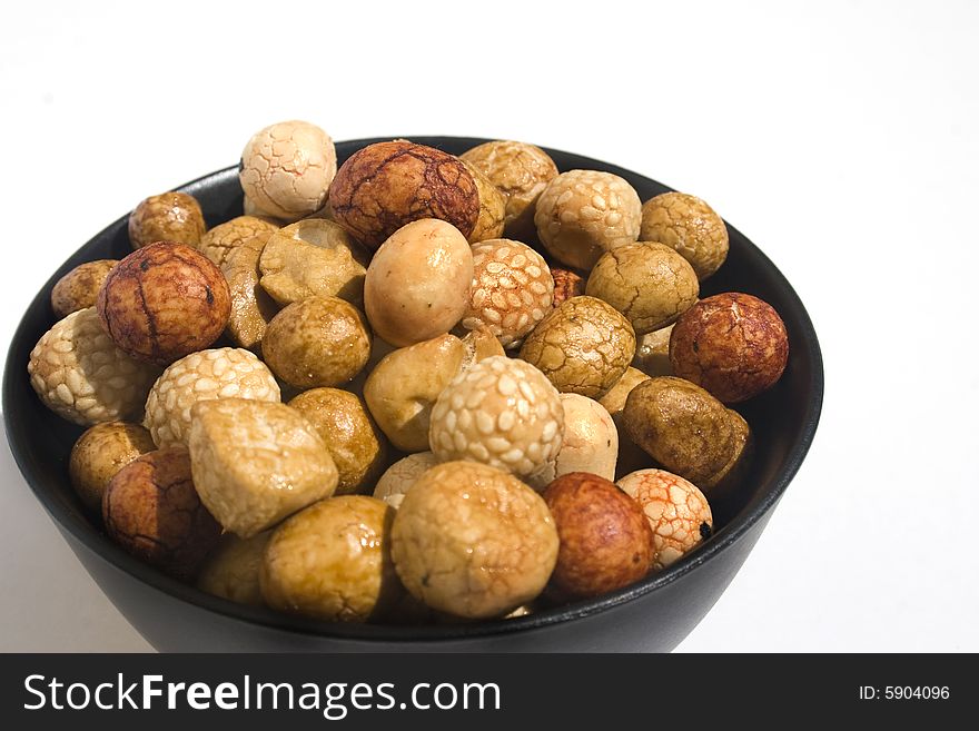 Bowl of Asian rice and sesame crackers against white background. Bowl of Asian rice and sesame crackers against white background