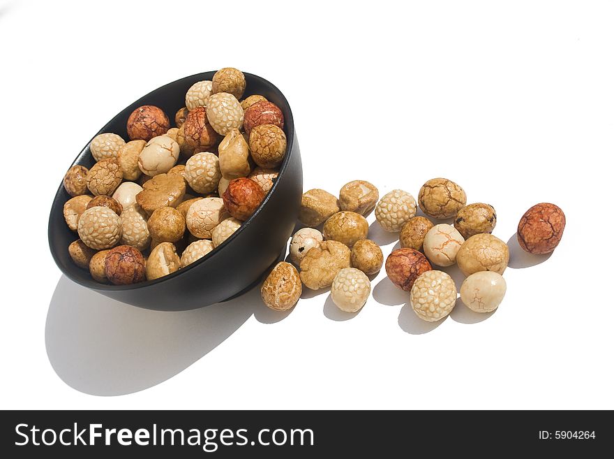 Bowl of Asian rice and sesame crackers against white background. Bowl of Asian rice and sesame crackers against white background