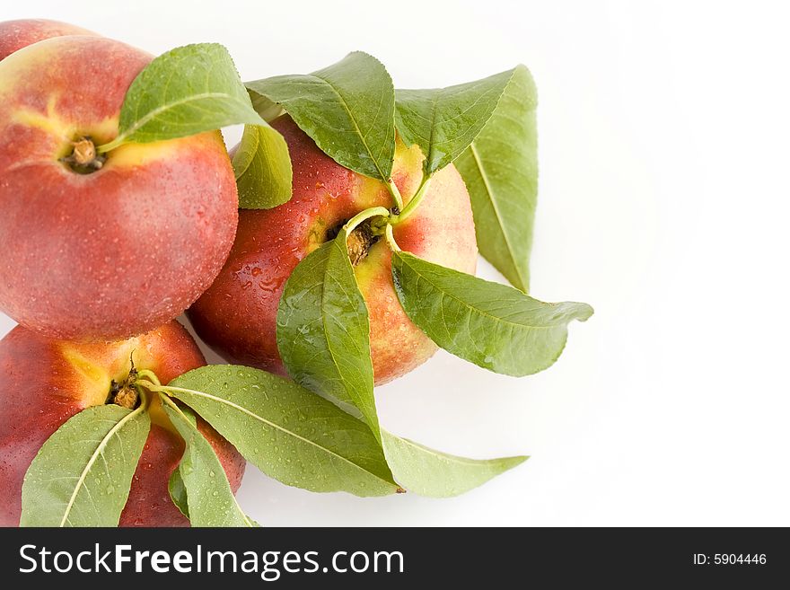 Ripe peach fruit with green leaf isolated on white background. Ripe peach fruit with green leaf isolated on white background