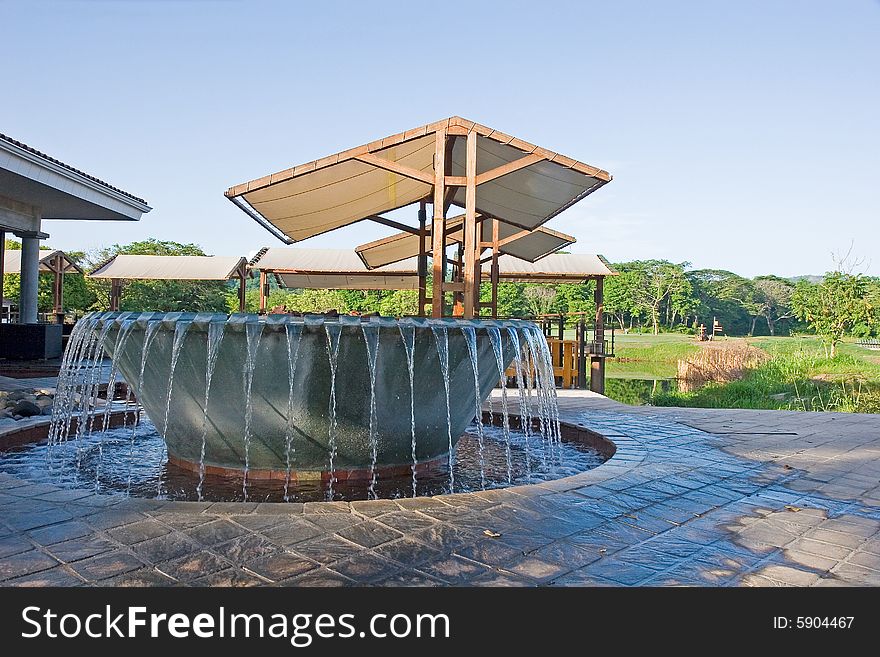 A Fountain in a park at a tropical golf course. A Fountain in a park at a tropical golf course