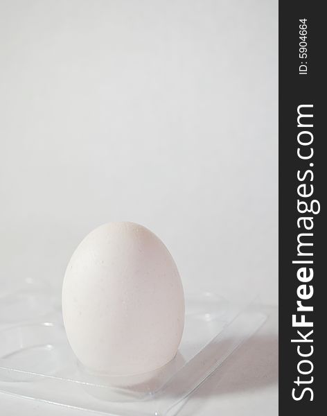 White egg on a stand on a white background