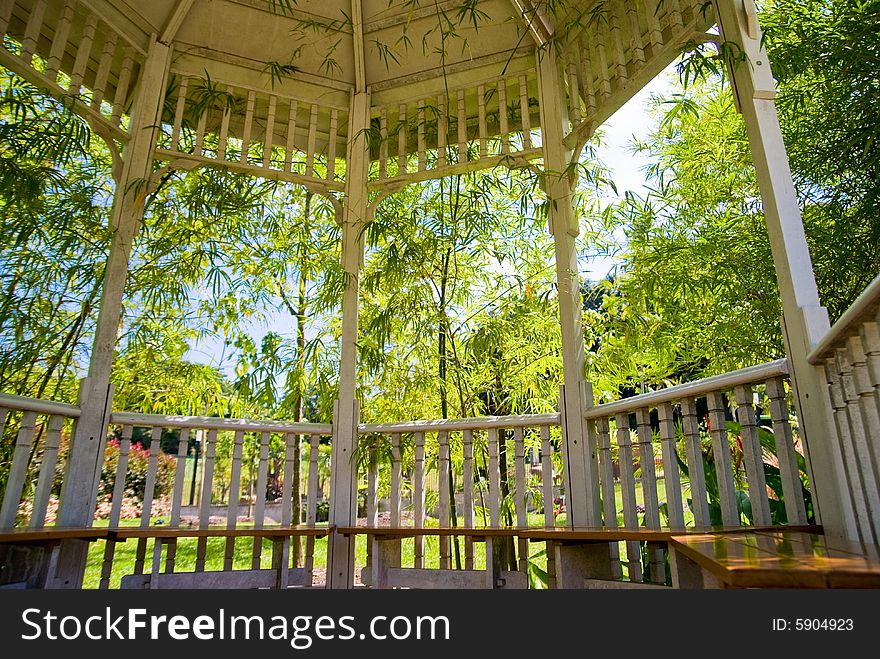 A pavilion in a bamboo grove in a tropical garden. A pavilion in a bamboo grove in a tropical garden